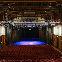 A full landscape shot of Elliott Hall showing stage and seating.