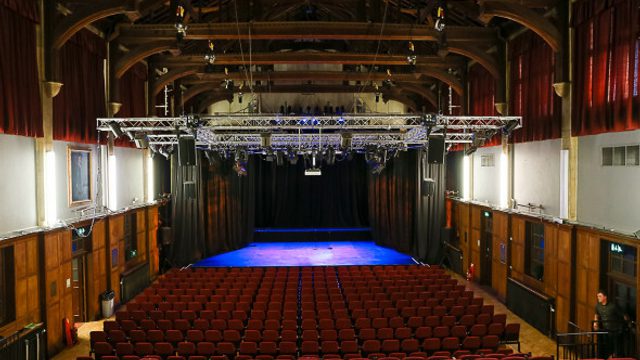 A full landscape shot of Elliott Hall showing stage and seating.