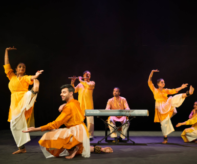 Dancers on stage performing traditional Indian dance