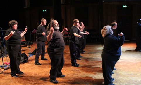 A group of performers on stage dancing.