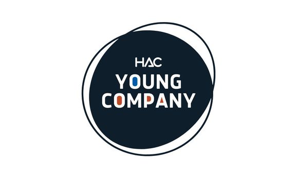 A solid navy circle with HAC logo and Young Company written in the centre in white text