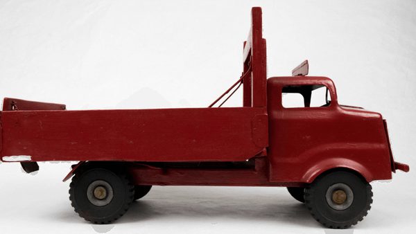 A red toy truck with black wheels on a white background.