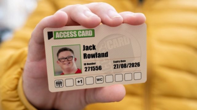 Person holding a photo id card for the nimbus access scheme with face thumbnail, name, and expiry date