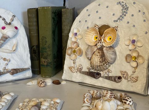 Handcrafted clay decoration depicting an owl at night, using shells, inspired by the shell grotto at Margate