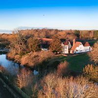 An aerial shot of the carpark on the left, moat and manor house. Picture has been taken from a far.